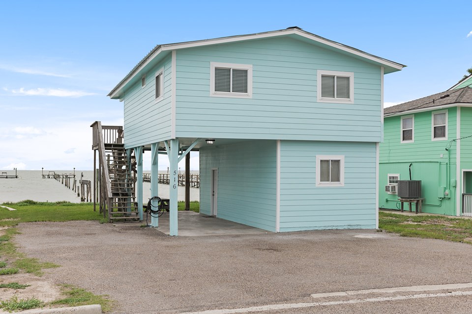 this waterfront home has been beautifully remodeled with new wiring, new roof, etc, there are two bedrooms with one full bath upstairs and has one large bunk room downstairs, one full bath, washer and dryer downstairs. there is plenty of parking under the carport and on the side of the home.