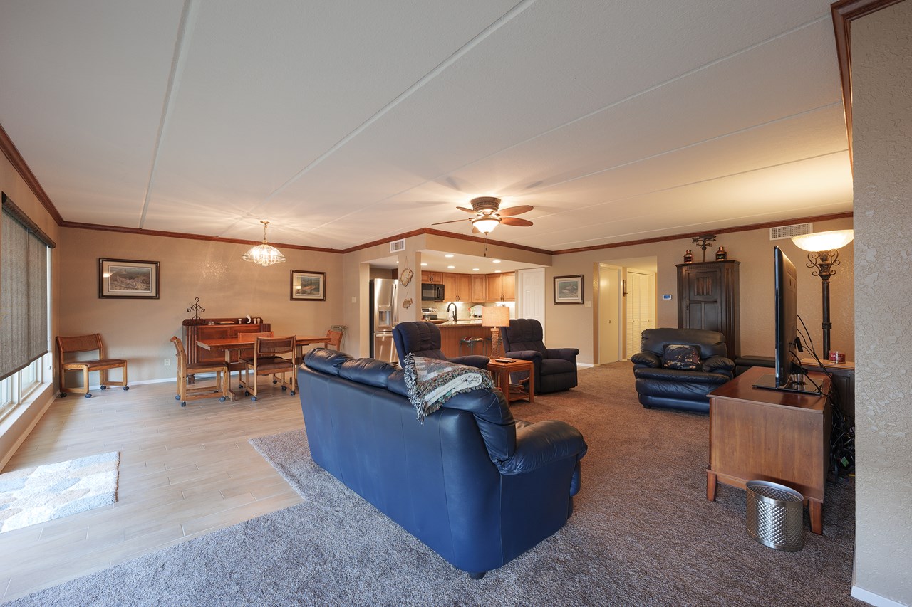 the hallway to the bedrooms, baths and washer/dryer is in the background center