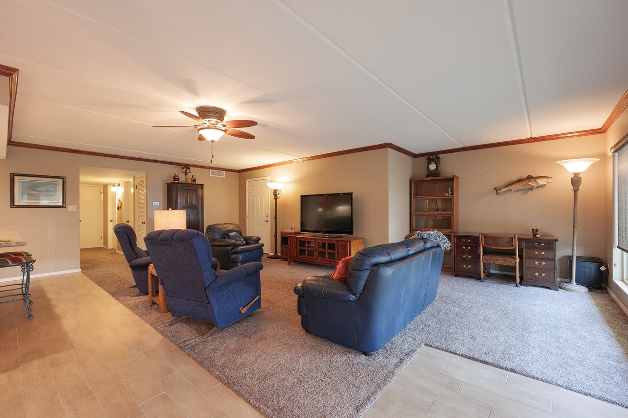 in the background to the left of the tv is the main entrance from the stairway
