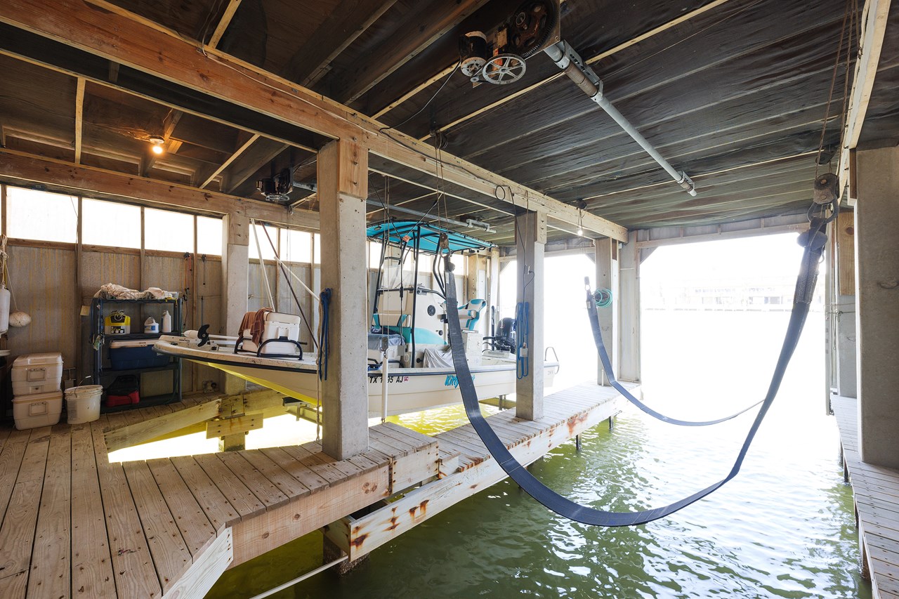 this boat house underneath the deck is also shared with the condo upstairs. the owner's of this condo have access to the right side of the covered boat slip.