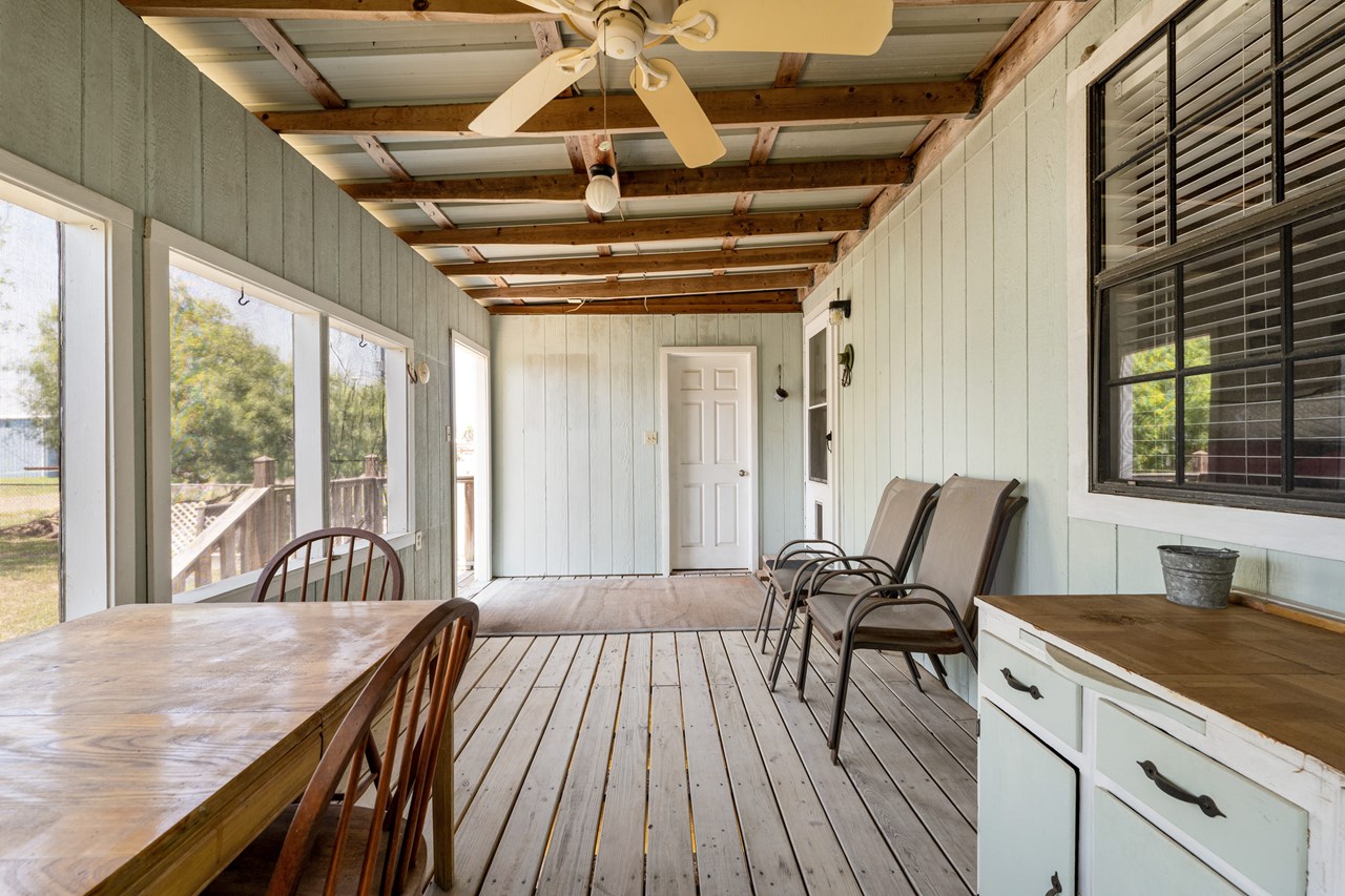 screened-in deck in the rear of the home overlooking the back yard the doorway in the background on your right leads to the laundry room
