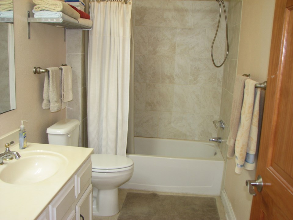 full bath upstairs with tile surround tub and shower