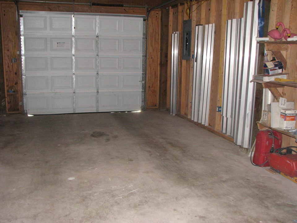 attached two car garage the metal pieces you see in the garage are the windstorm shutters for the windows upstairs.