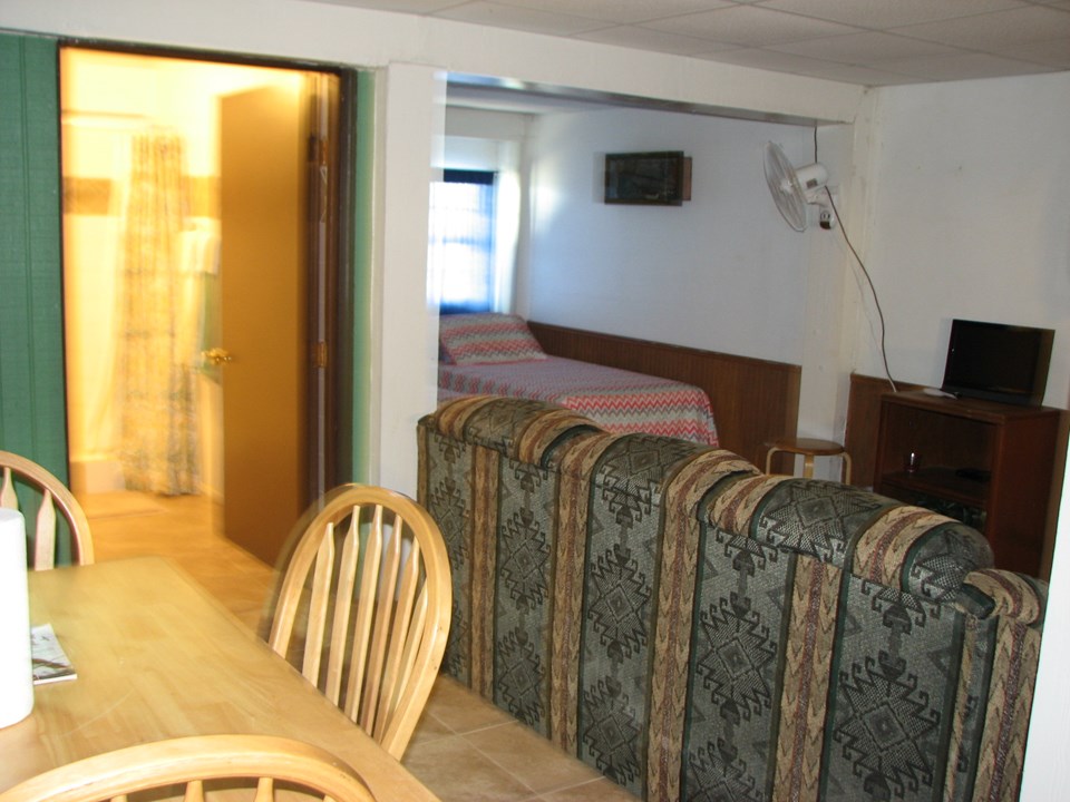 downstairs there are three single beds, dining table, living area, full shower