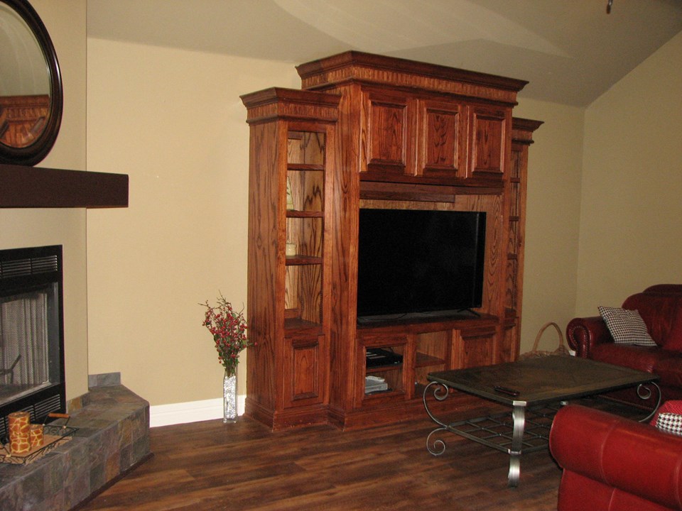 living room with working fireplace; custom cabinet for tv, etc.