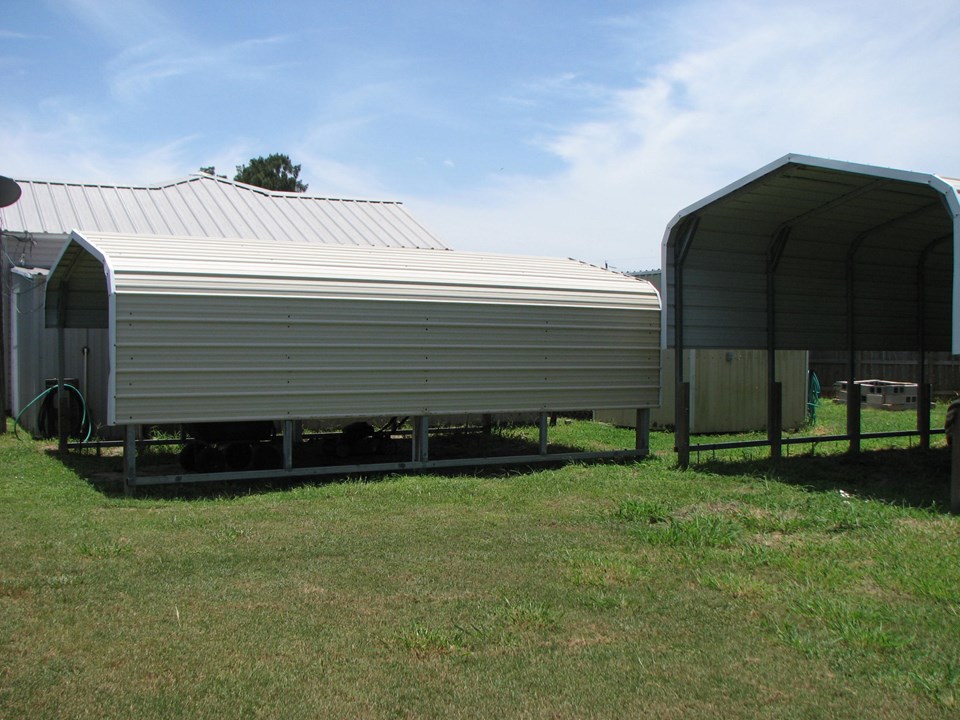 the carport to your left is 12' wide and 8' high there is also another storage shed in the background as well as another small covered open area behind the storage shed.