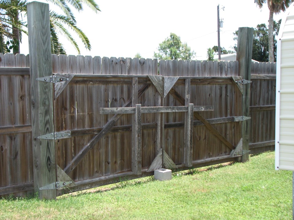 there are two double gates leading to each carport from the street side the fence is six foot high completely encircling the property.