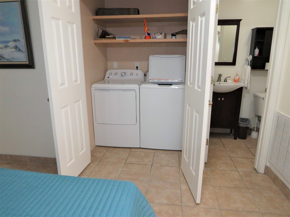 in the master bedroom is located the washer and dryer and a potty room on the right