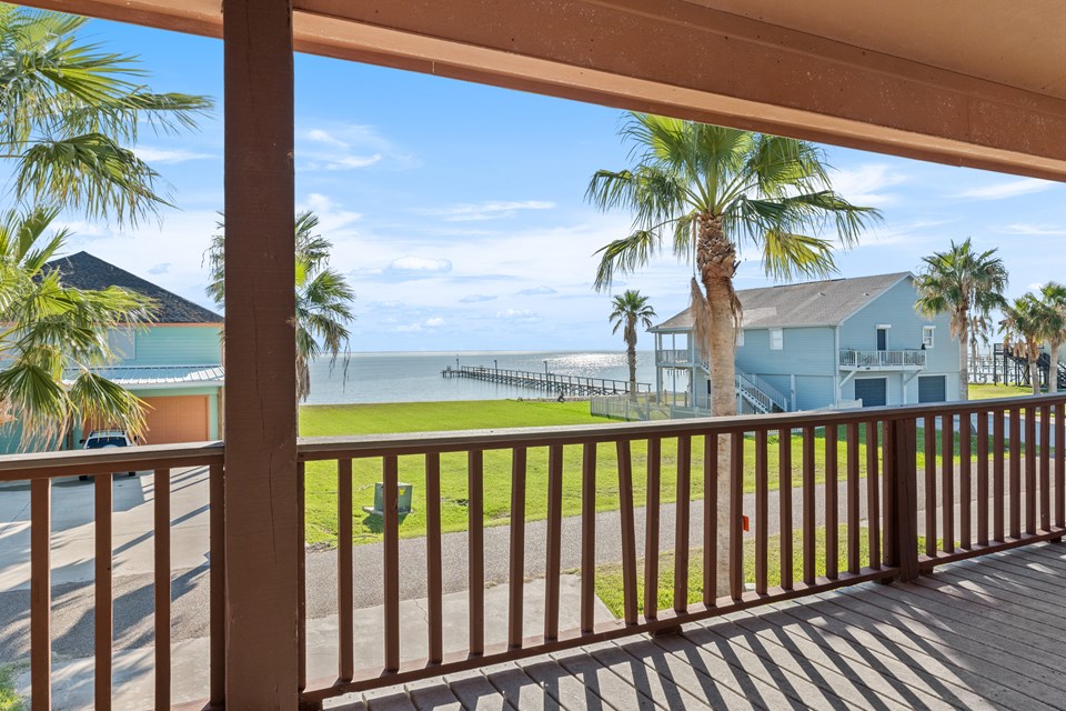 sit out on your covered deck and experience those beautiful sunrises over the laguna bay! this beautiful home is located across the street from the lower laguna madre bay.  the next door neighbor to the south purchased the vacant lot across the street so that no one would buy and the lot and build a house, thus eliminating his wonderful, unobstructed view.