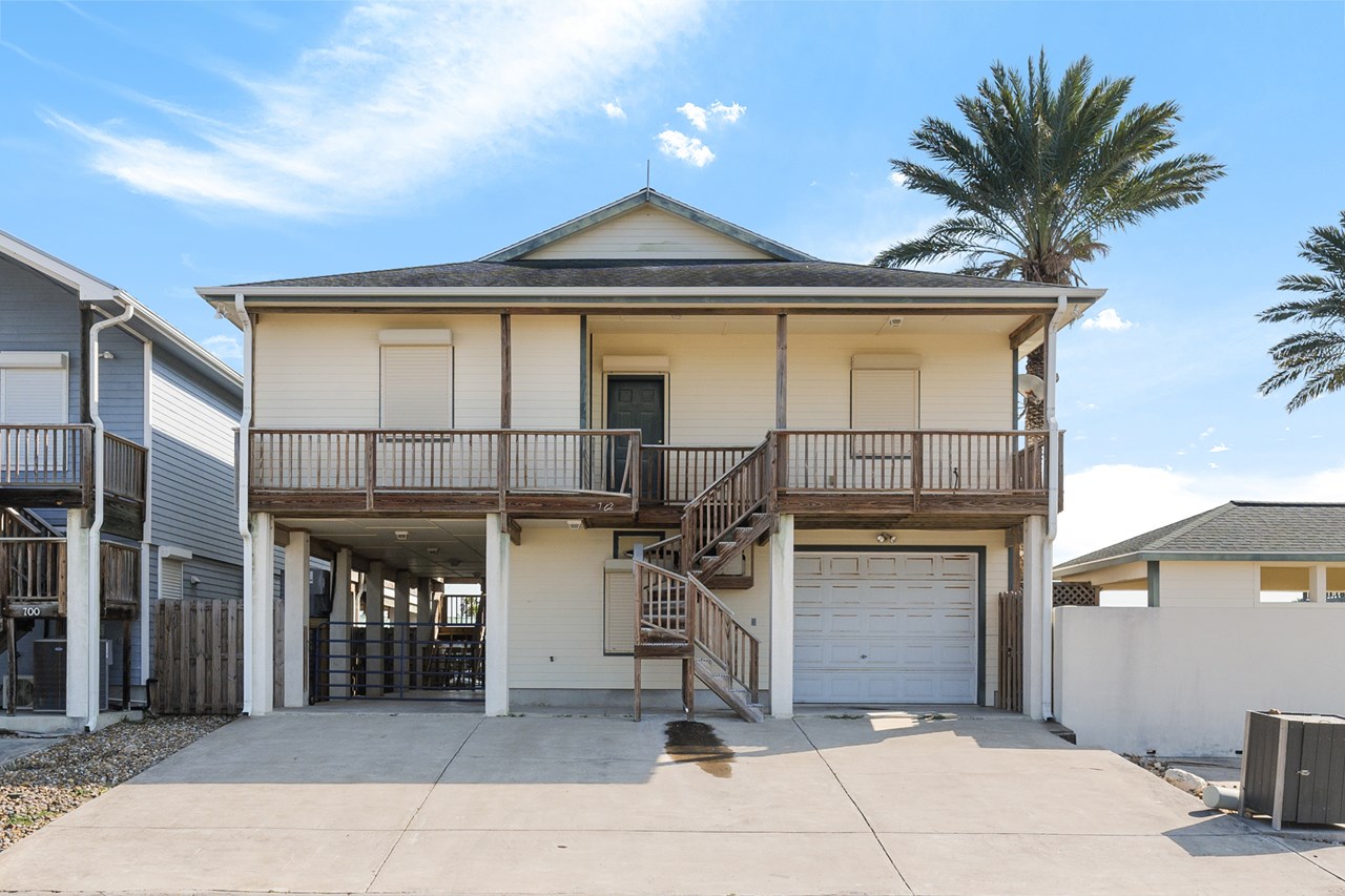 street view of home the enclosed garage is on your left; the guest house is in the center; and the covered carport is on your left.